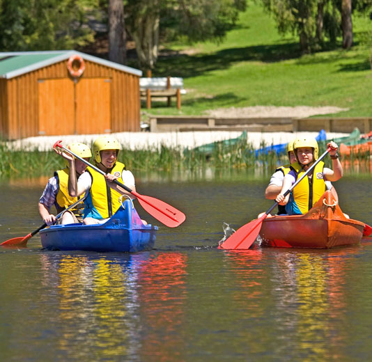 Two canoes on the lake with two people in each